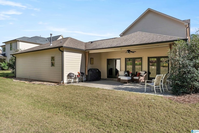 rear view of property featuring a lawn, a patio area, and ceiling fan