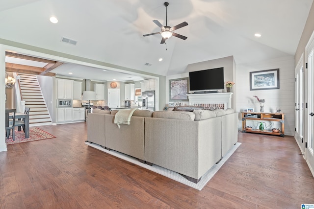 living room with ceiling fan, hardwood / wood-style floors, high vaulted ceiling, and beamed ceiling