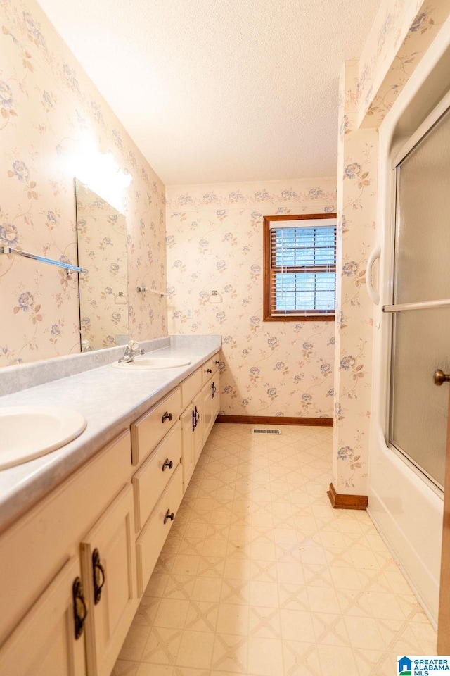 bathroom with vanity and enclosed tub / shower combo