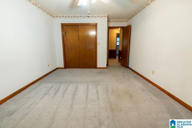 unfurnished bedroom featuring ceiling fan and light colored carpet