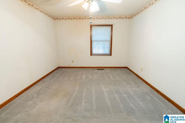 carpeted empty room featuring ceiling fan