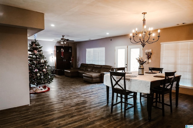 dining space featuring french doors, ceiling fan with notable chandelier, and dark hardwood / wood-style floors