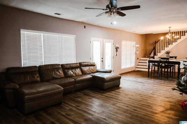 living room with french doors, ceiling fan with notable chandelier, and dark hardwood / wood-style floors