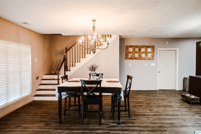 dining room featuring a chandelier and dark wood-type flooring