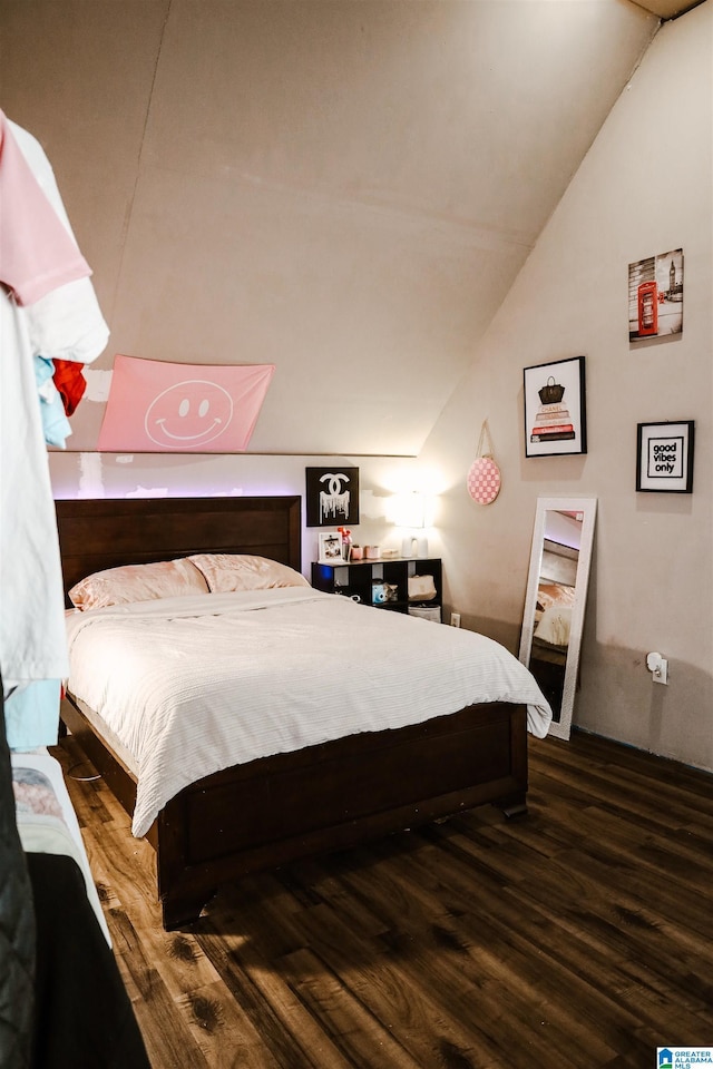 bedroom featuring hardwood / wood-style flooring and vaulted ceiling