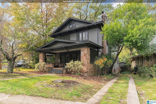 view of front facade featuring a front lawn and covered porch