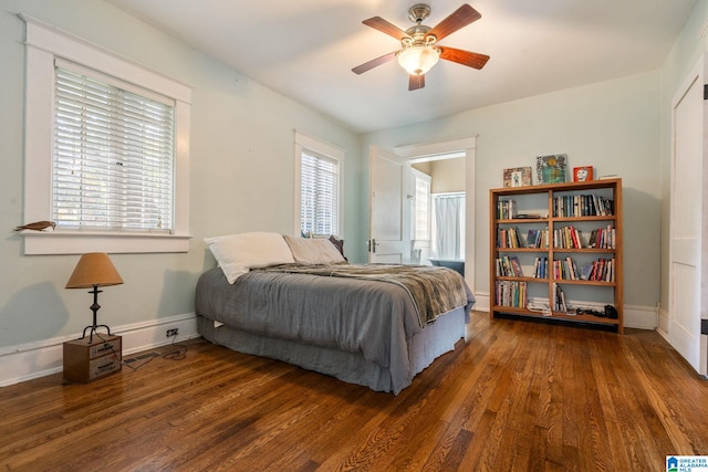 bedroom featuring ceiling fan and dark wood-type flooring