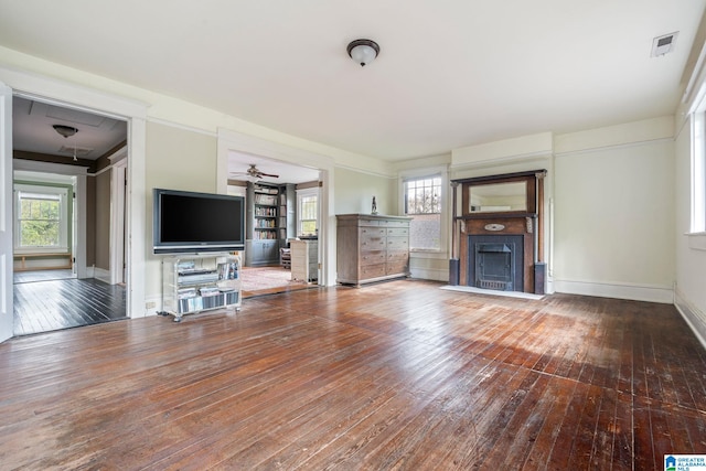 unfurnished living room with ceiling fan, a healthy amount of sunlight, and hardwood / wood-style flooring