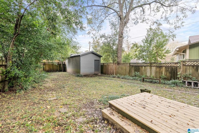 view of yard featuring a storage unit and a wooden deck