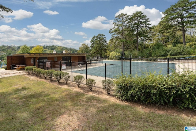 view of swimming pool with tennis court