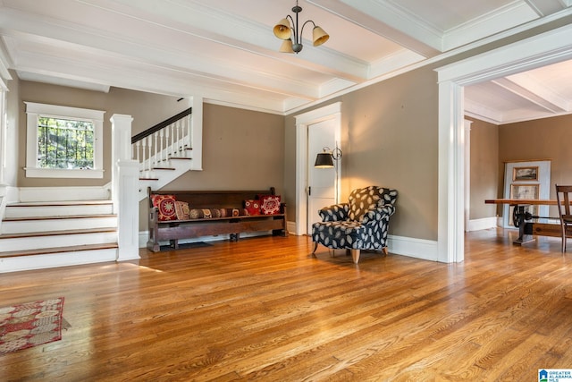 interior space featuring hardwood / wood-style flooring, a notable chandelier, beam ceiling, and crown molding