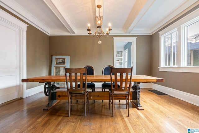 dining room featuring crown molding, wood-type flooring, and a notable chandelier