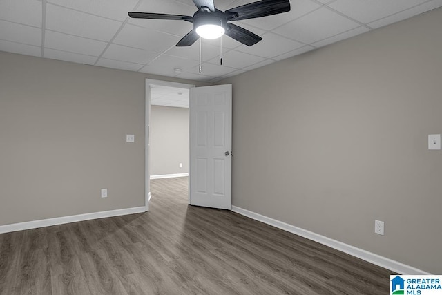 unfurnished room featuring hardwood / wood-style flooring, ceiling fan, and a drop ceiling