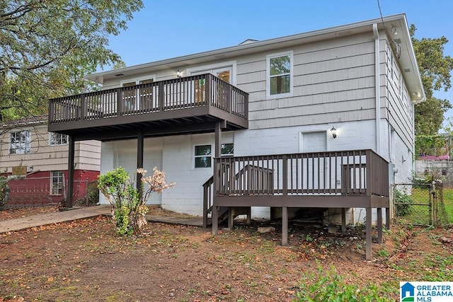 back of property with a wooden deck