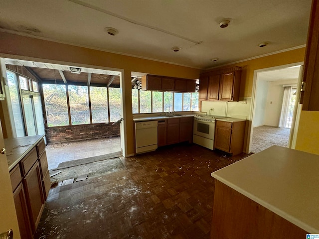 kitchen featuring crown molding, sink, and white appliances