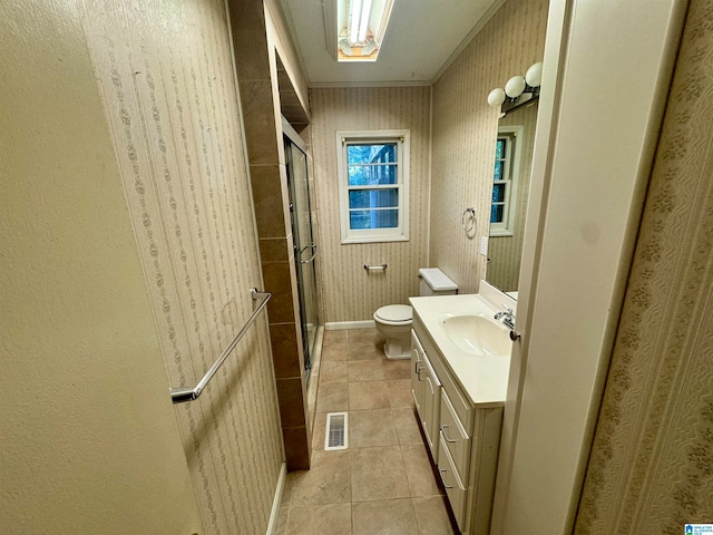 bathroom with tile patterned floors, walk in shower, vanity, crown molding, and toilet