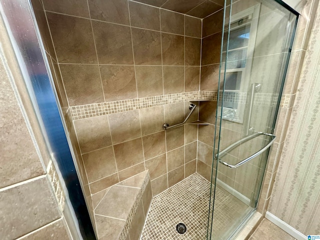 bathroom with a shower with door