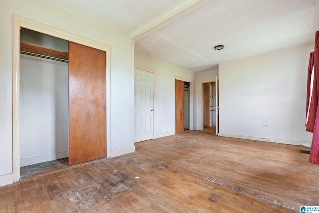 unfurnished bedroom featuring hardwood / wood-style floors