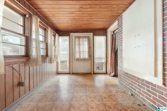 unfurnished sunroom with wood ceiling