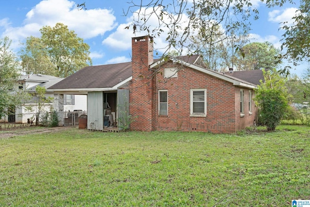 back of house with a yard