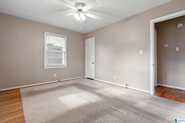 empty room featuring hardwood / wood-style floors and ceiling fan