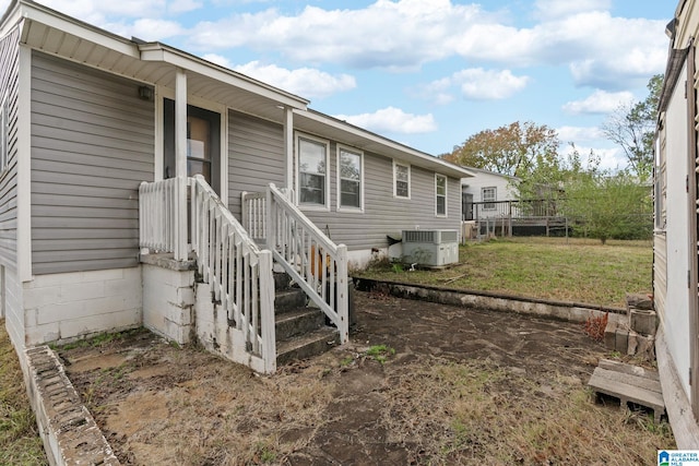 view of home's exterior with a yard and central air condition unit