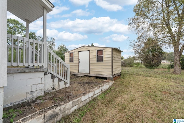 view of outbuilding with a lawn