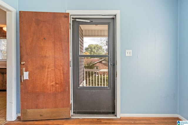 doorway to outside with wood-type flooring