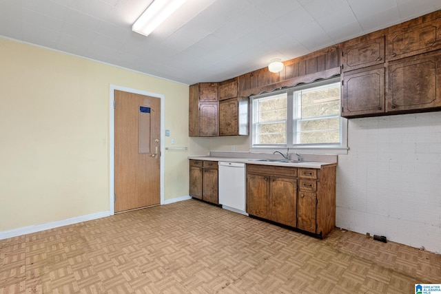 kitchen with dishwasher, light parquet flooring, and sink