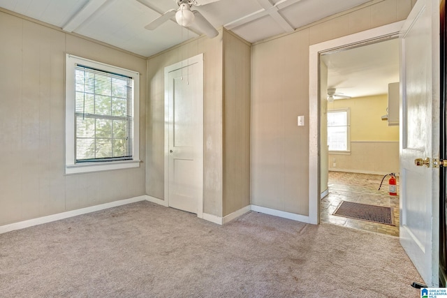 unfurnished bedroom featuring multiple windows, ceiling fan, a closet, and light colored carpet