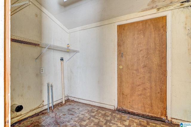 laundry room with dark parquet floors