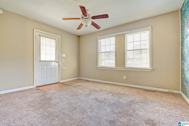 carpeted empty room featuring ceiling fan