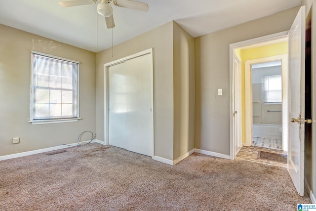 unfurnished bedroom with ceiling fan, light colored carpet, and a closet