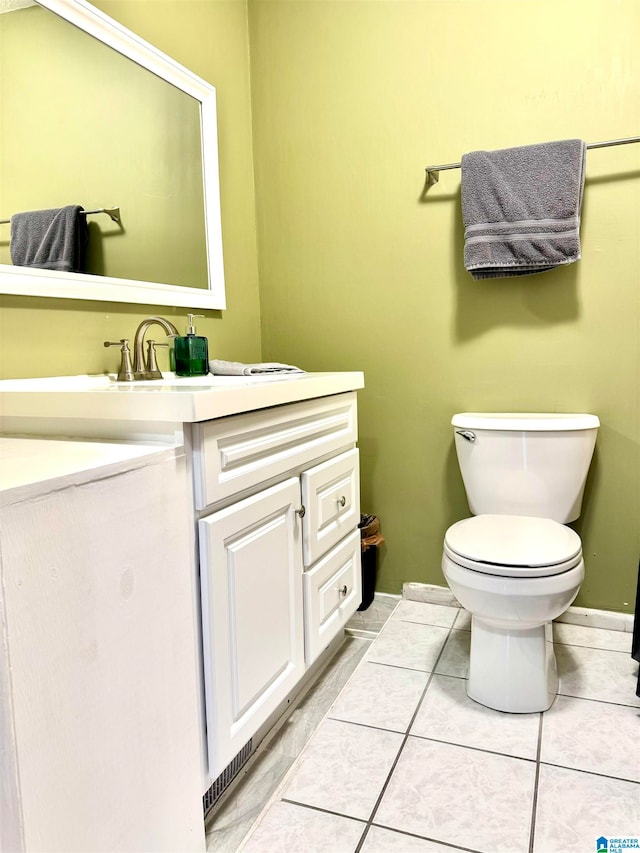 bathroom featuring tile patterned flooring, vanity, and toilet