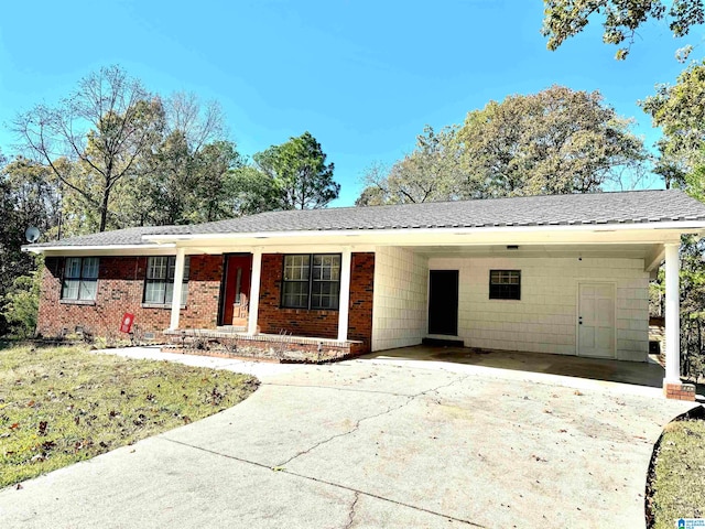 single story home featuring covered porch and a carport