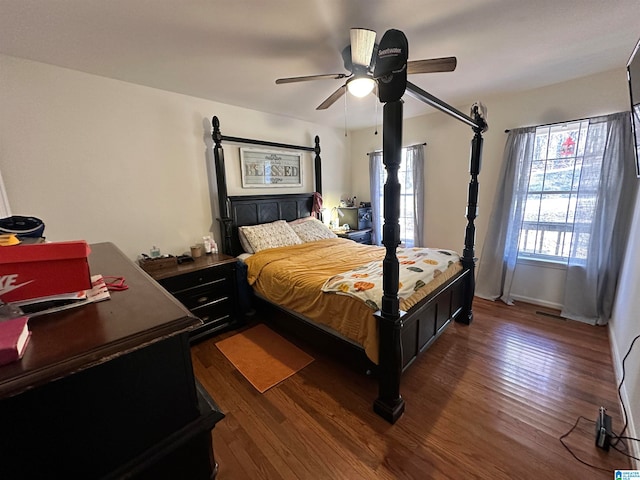 bedroom featuring ceiling fan and dark wood-type flooring