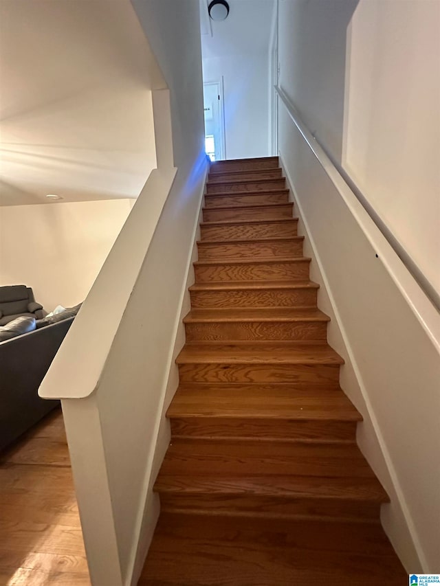 stairs with hardwood / wood-style flooring