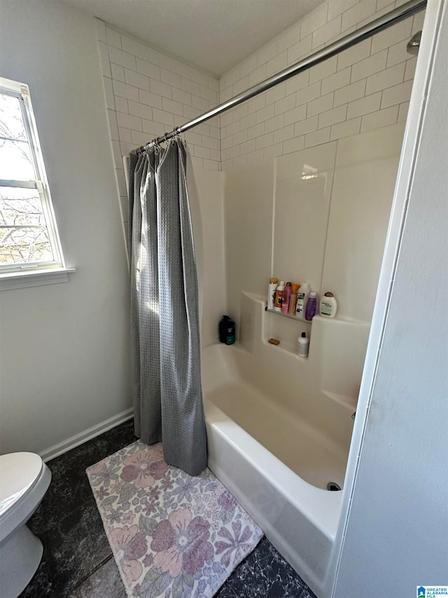 bathroom featuring toilet and shower / tub combo