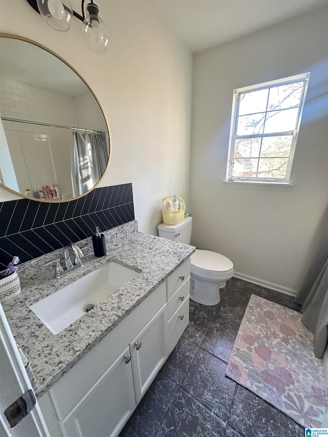 bathroom featuring vanity, a shower with shower curtain, and toilet