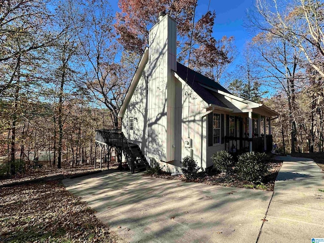 view of side of home featuring covered porch