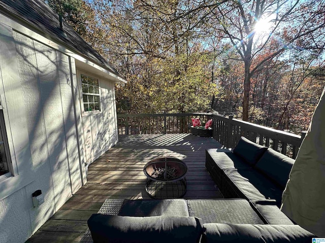 deck with an outdoor living space with a fire pit