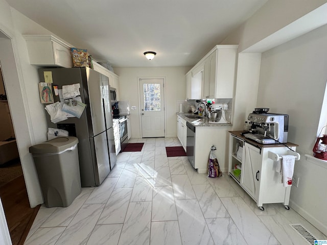 kitchen featuring sink, white cabinetry, and stainless steel appliances