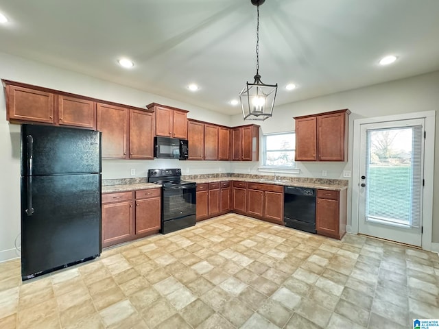 kitchen with black appliances, decorative light fixtures, a healthy amount of sunlight, and a notable chandelier