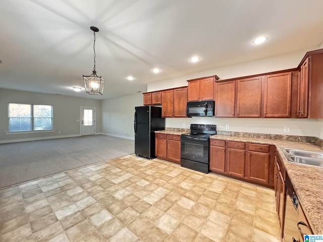 kitchen featuring black appliances, decorative light fixtures, sink, and a chandelier