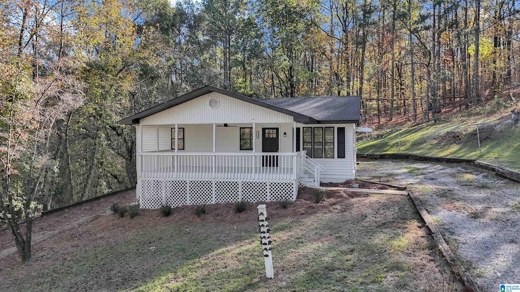 view of front of house with a porch and a front lawn