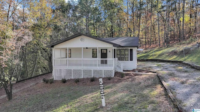 view of front of house with a porch and a front lawn