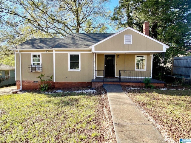 ranch-style home with covered porch and a front lawn