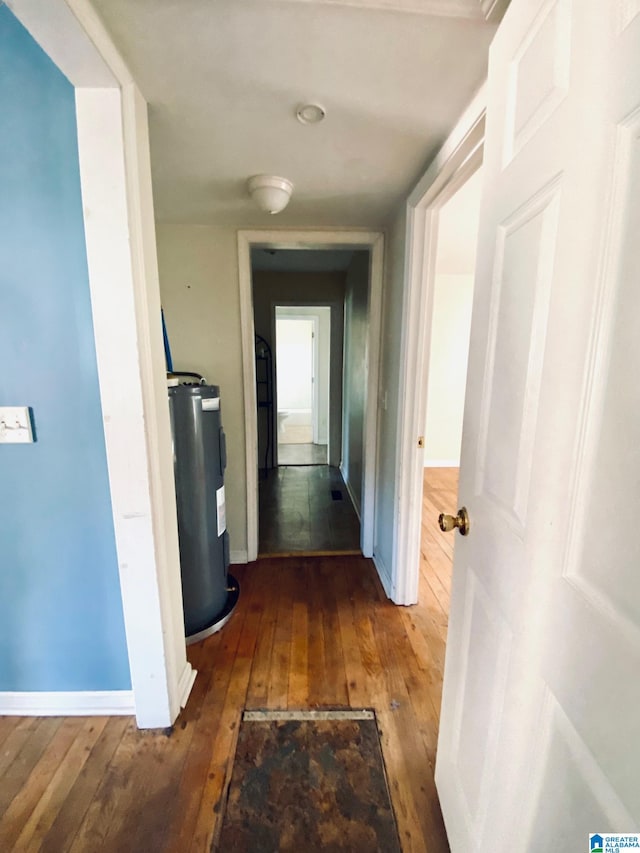 hall featuring hardwood / wood-style floors and electric water heater