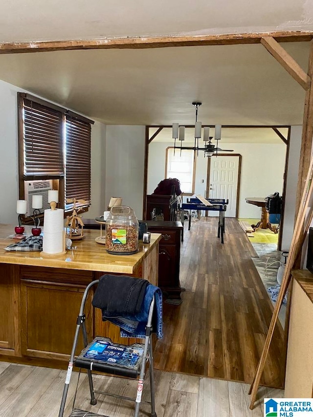 kitchen featuring hardwood / wood-style floors, butcher block countertops, cooling unit, and a notable chandelier