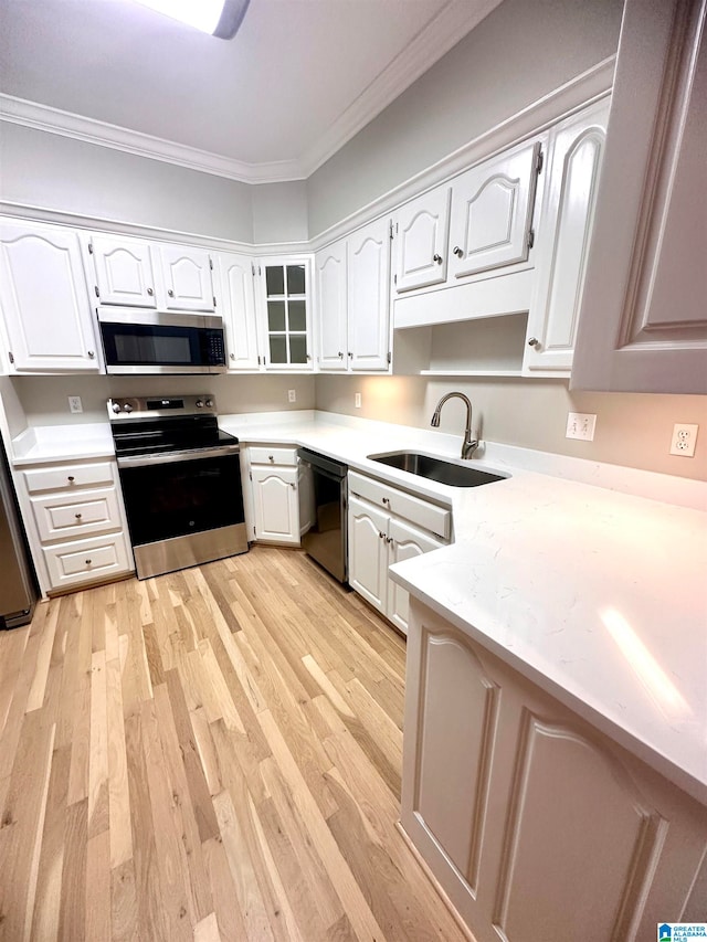 kitchen featuring white cabinetry, sink, and stainless steel appliances